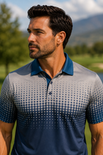 Load image into Gallery viewer, A man wearing a short-sleeve polo shirt with a gray-to-blue gradient and a diamond pattern, standing outdoors on a golf course with mountains in the background.