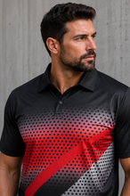 Load image into Gallery viewer, A man wearing a black short-sleeve polo shirt with a red and gray diagonal graphic pattern and a black dot gradient design on the front, set against a gray concrete wall.