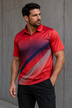 Load image into Gallery viewer, A man wearing a red short-sleeve polo shirt with a diagonal halftone gradient pattern in navy blue, gray, and red, paired with black cargo pants, standing against a concrete wall.