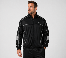 Load image into Gallery viewer, A man wearing a black athletic zip-up jacket with white piping and reflective gray sleeve panels, paired with black track pants, photographed against a light gray studio background.
