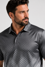 Load image into Gallery viewer, A close-up of a man wearing a dark gray short-sleeve polo shirt with a white halftone dot gradient pattern on the front, set against a plain light gray background.
