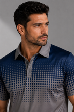 Load image into Gallery viewer, A man wearing a short-sleeve polo shirt with a gradient design that transitions from dark navy blue with a dotted pattern at the top to a solid gray at the bottom, against a neutral gray background.
