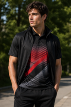 Load image into Gallery viewer, A man wearing a black athletic zip-up vest over a black polo shirt with a red and gray halftone diagonal graphic, standing outdoors on a paved path with trees in the background.

