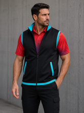 Load image into Gallery viewer, A man wearing a black zip-up athletic vest with bright turquoise blue trim over a red patterned short-sleeve shirt and black cargo pants, standing against a gray concrete wall.
