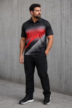 Load image into Gallery viewer, A man wearing a black short-sleeve polo shirt with a red, black, and gray halftone graphic on the front, paired with black cargo pants and black sneakers, standing against a textured gray concrete wall.
