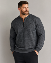 Load image into Gallery viewer, A man wearing a dark heather gray quarter-zip pullover sweater with a small black embroidered logo on the left chest, paired with black pants, against a solid gray studio background.
