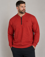 Load image into Gallery viewer, A man wearing a heathered red long-sleeve quarter-zip pullover sweatshirt with a small embroidered logo on the chest, paired with dark pants, against a solid gray studio background.
